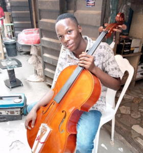 Nigerian Student Chibuike Victor receives his own cello.
